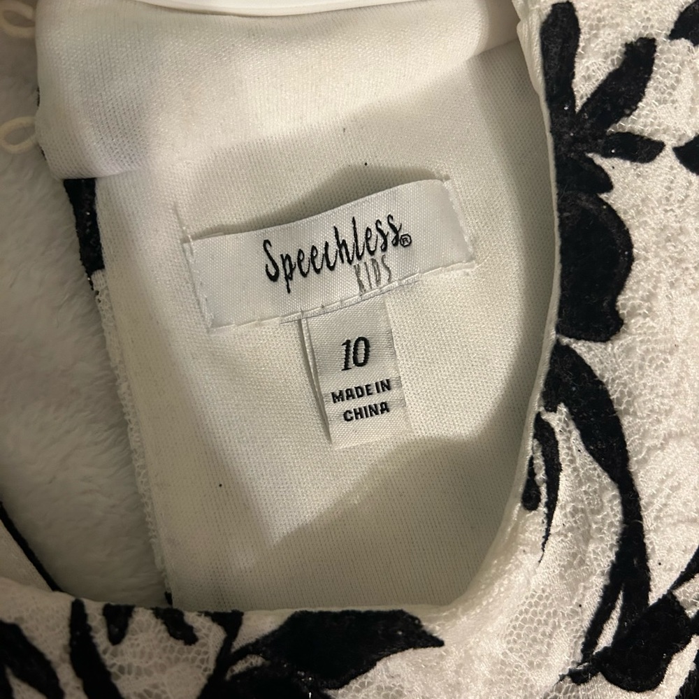 Size 10, black and white dress, the bottom of the dress; the fabric is folded